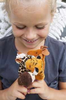 A little girl playing games with her finger puppets