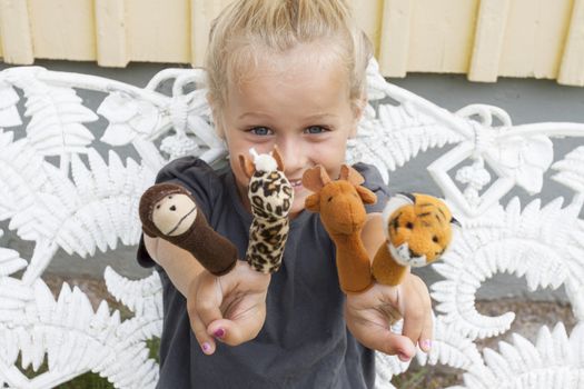 A little girl playing games with her finger puppets. Short depth of field, sof focus