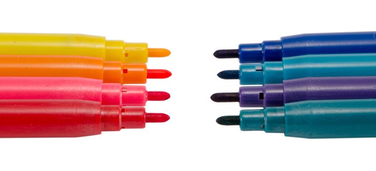 dark color felt tip pens in front of bright color oponents without caps plugs isolated on white.