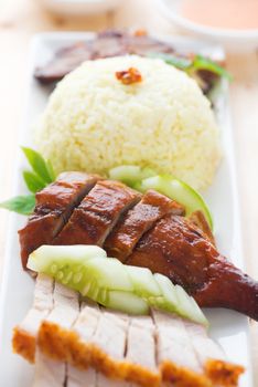 Roasted duck and roasted pork crispy siu yuk, Chinese style, served with steamed rice on dining table. Malaysia cuisine.