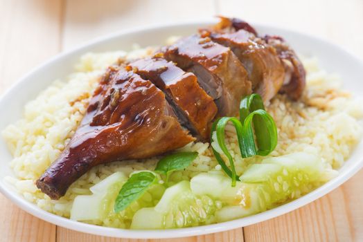 Roasted duck, Chinese style, served with steamed rice on dining table. Singapore cuisine.