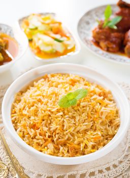 Biryani rice or briyani rice, curry chicken and salad, traditional indian food on dining table.