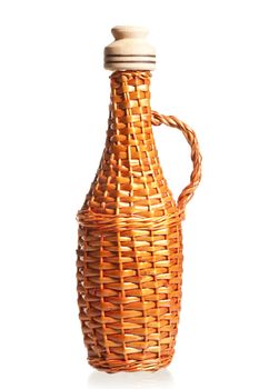 straw wicker bottle for oil with cork on a white background