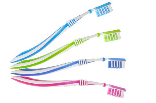 four new multi-colored toothbrushes are on a white background