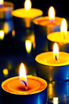 A group of small candles on a dark background
