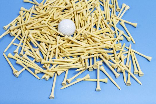 A bunch of golf tees on a blue background.