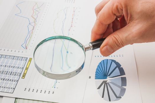 Graphs tables and documents laid on the table