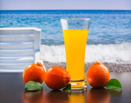 orange juice in a glass on a table with oranges