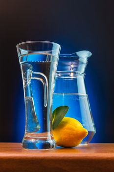 mineral water and lemon on a colored background