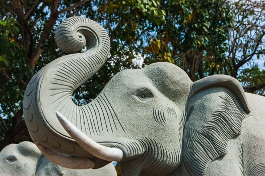 Thai stone elephant on a pedestal on a sunny day in Thailand