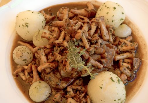 Beef casserole with mushrooms, onions and potatoes.