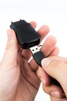 Man using black USB phone charger