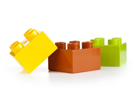 Plastic toy blocks on white background. Group of building blocks