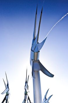 Modern steel fish sculptures in Cairns, Australia, raised on poles in the swimming lagoon at the Esplanade