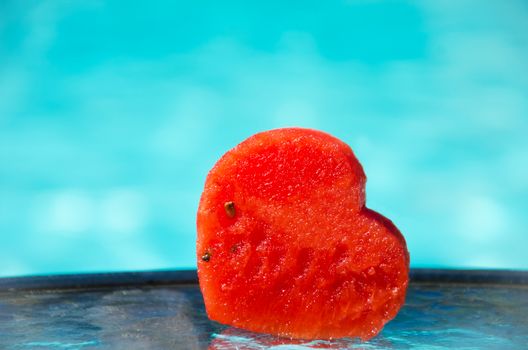 Watermelon Heart shape by the swimming pool - holiday concept