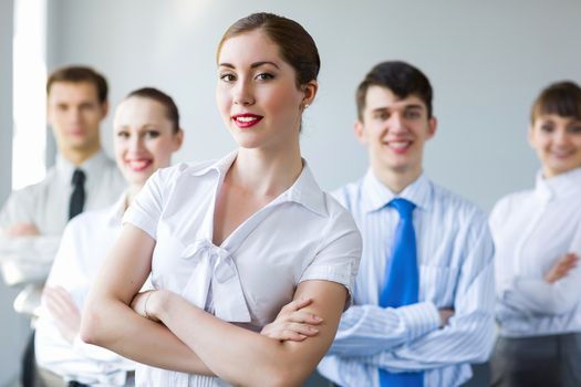 Young smiling businesswoman with colleagues. Leadership concept