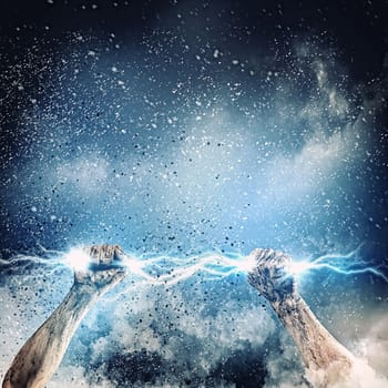 Close-up of human hand clenching lightning flash