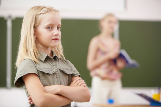 Little blonde girl studying at school class