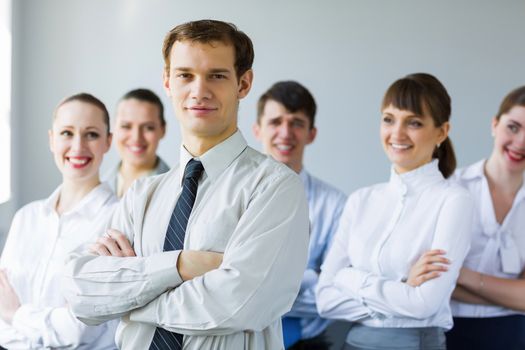 Young business people standing with arms crossed on chest