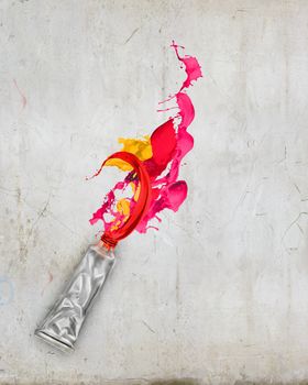 Image of paint tube with color splashes