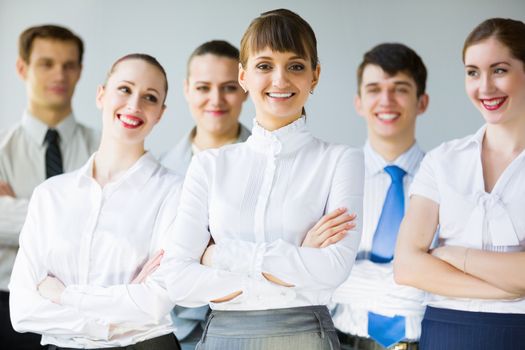 Young business people standing with arms crossed on chest