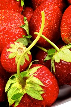 Fresh Sweet Strawberries with Stems closeup as Background