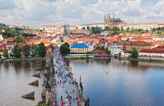 Tourists on Charles Bridge, Jule 30, 2013, Prague,Czech Republic. Annually Prague is visited by more than 3,5 million tourists