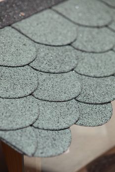 Rounded overlapped roof tiles viewed close up from above to show the pattern and texture