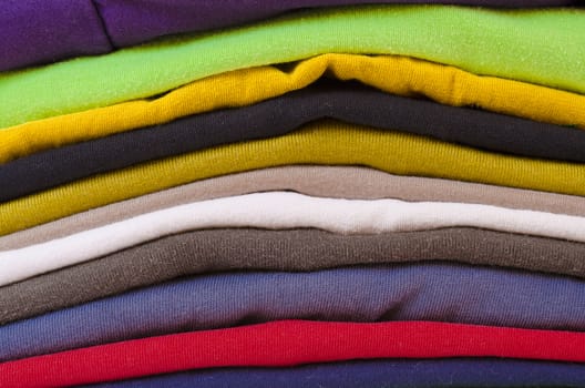 close up of a colorful stack of folded clothes