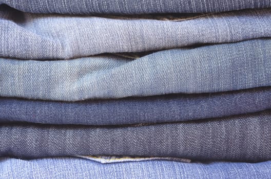 close up of a stack of folded jeans horizontally cropped