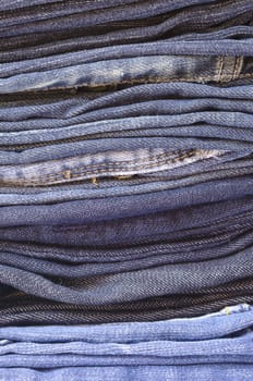 close up of a stack of folded jeans vertically cropped