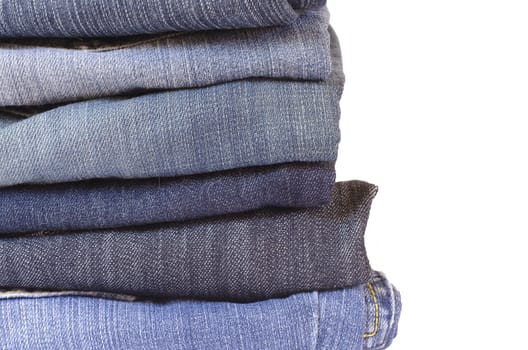 stack of folded jeans on white background