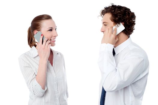Young office colleagues communicating over cellphone