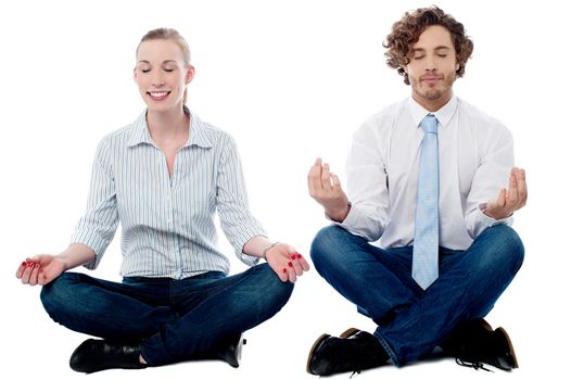 Business executives meditating in lotus posture