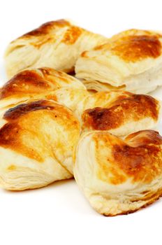 Fluffy Puff Pastry Bakery Bows In a Row isolated on white background. Selective Focus