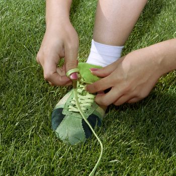 girl ties laces on the sports shoes