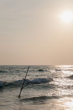 The stick of Sri Lankan fisherman in ocean.
