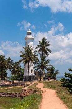 Lighthouse in Galle among the palms, Sri Lanka