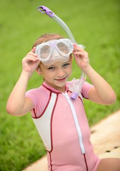 pretty girl with goggles and snorkel in summertime