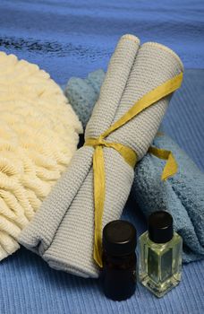 assortment of spa products on blue with essential oils for aromatherapy