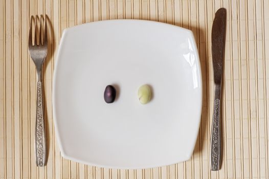 Two pods to choose from on a white square plate.