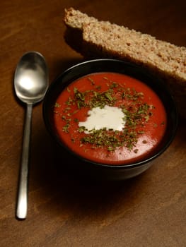 savory tomato soup and bread in rustic and cozy setting