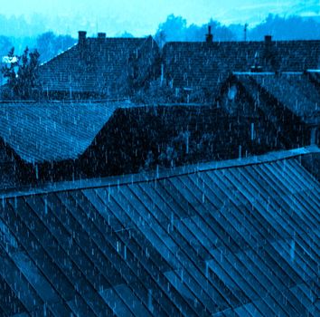 background rain over the rooftops toned in blue color