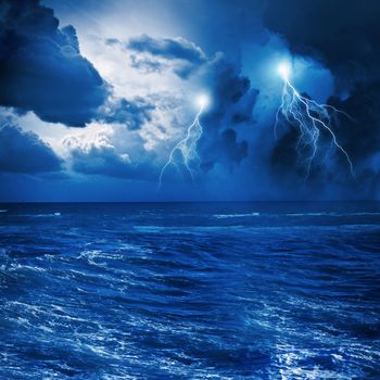 Image of night stormy sea with big waves and lightning