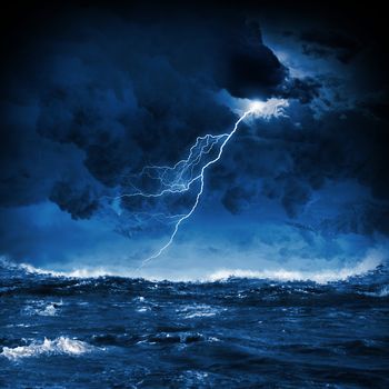 Image of night stormy sea with big waves and lightning