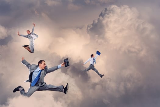 Image of businesspeople jumping high in sky