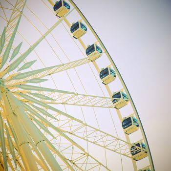 Ferris wheel with blue sky with retro effect