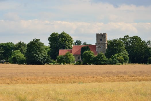 Church with harvest field in foreground