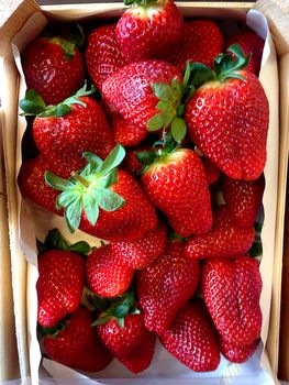 Fresh, ripe strawberries in a wooden basket