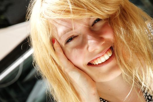 A smiling young woman in the sunlight